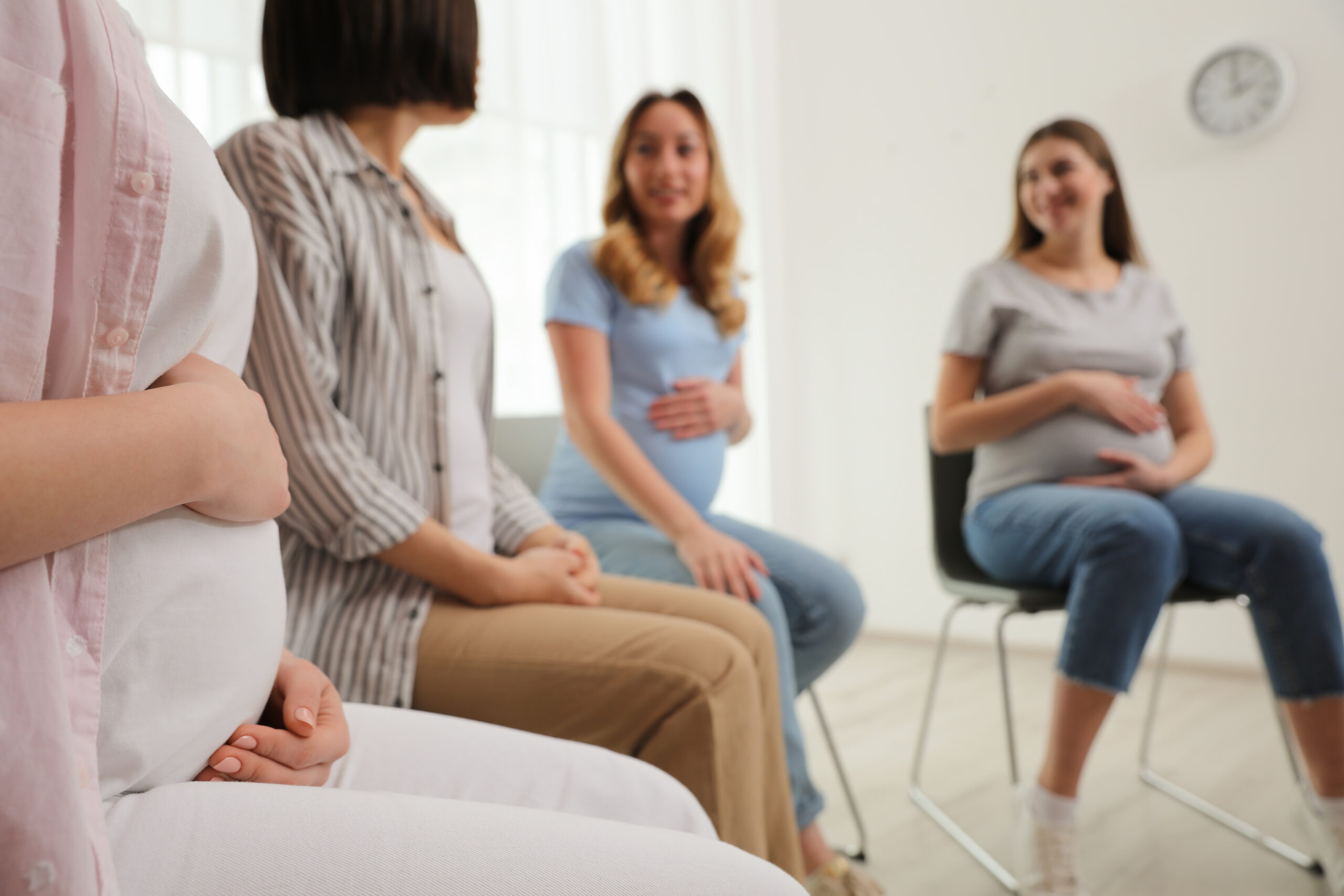 Group of pregnant women at courses for expectant mothers indoors